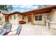 Inviting patio area with built-in grill and comfortable seating under wood ceiling at 4456 Mohawk Dr, Larkspur, CO 80118