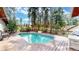Relaxing pool surrounded by a wooden deck and tall pine trees at 4456 Mohawk Dr, Larkspur, CO 80118