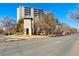 Spacious condo building with a beautiful stone clock tower and mature trees at 601 W 11Th Ave # 409, Denver, CO 80204