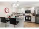 Modern kitchen with granite countertops, stainless steel appliances, breakfast bar with seating, and neutral backsplash at 601 W 11Th Ave # 409, Denver, CO 80204