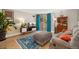 Inviting living room featuring a comfortable couch, stylish rug, and bright natural light from the sliding glass door at 601 W 11Th Ave # 409, Denver, CO 80204