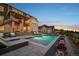 Stunning backyard featuring a modern pool, landscaped patio area, and ample space for outdoor entertaining and relaxation at 5625 Heritage Oak Dr, Parker, CO 80134