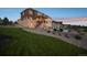 Expansive backyard featuring a large lawn, patio with seating, and a beautiful pool, perfect for outdoor enjoyment at 5625 Heritage Oak Dr, Parker, CO 80134