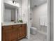 Bathroom featuring wood vanity, quartz countertop, and separate toilet room offer practical elegance at 5625 Heritage Oak Dr, Parker, CO 80134