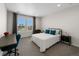 Cozy bedroom featuring a plush bed, neutral color scheme, grey curtains, desk and ample natural light at 5625 Heritage Oak Dr, Parker, CO 80134