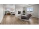 Bright bedroom with hardwood floors, fireplace, sitting area and views from the windows at 5625 Heritage Oak Dr, Parker, CO 80134