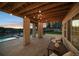 Charming covered patio with stone pillars and string lights, offering an inviting space for relaxation and entertaining at 5625 Heritage Oak Dr, Parker, CO 80134