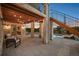 Elegant covered patio with stone pillars, a wooden pergola, and stylish furniture, perfect for enjoying outdoor living at 5625 Heritage Oak Dr, Parker, CO 80134
