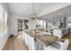Open concept dining area with hardwood floors, slider doors, light fixture, and easy access to the kitchen at 5625 Heritage Oak Dr, Parker, CO 80134