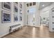 Bright foyer with hardwood floors, a bench, and views into the living room at 5625 Heritage Oak Dr, Parker, CO 80134