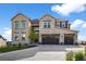 This well-manicured front exterior boasts a three-car garage and classic stone facade at 5625 Heritage Oak Dr, Parker, CO 80134