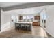 Eat-in kitchen with white island, seating, hardwood floors, and wood cabinets provides a bright cooking space at 5625 Heritage Oak Dr, Parker, CO 80134
