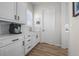 Well-lit kitchenette includes white cabinets, quartz countertop, coffee machine, and stainless steel faucet at 5625 Heritage Oak Dr, Parker, CO 80134