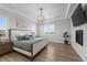 Spacious bedroom featuring tray ceiling, fireplace, hardwood floors and scenic windows at 5625 Heritage Oak Dr, Parker, CO 80134