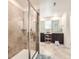 Luxurious bathroom with a glass-enclosed shower and double vanity sinks at 14437 Grape St, Thornton, CO 80602