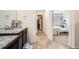 Bathroom with granite countertops, tile flooring, and closet access at 14437 Grape St, Thornton, CO 80602