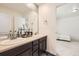 Bathroom featuring a dual vanity and a view of the living space at 14437 Grape St, Thornton, CO 80602