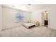 Bright bedroom with plush carpeting and an en-suite bathroom at 14437 Grape St, Thornton, CO 80602
