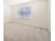 Empty bedroom with neutral walls, carpeted flooring, and one window for natural lighting at 14437 Grape St, Thornton, CO 80602