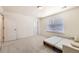 Bright bedroom featuring neutral walls, carpeted floors, and a futon sofa at 14437 Grape St, Thornton, CO 80602