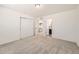 Bright bedroom boasts neutral walls, carpeted floor, closet, and ensuite bathroom access at 14437 Grape St, Thornton, CO 80602