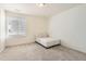 Minimalist bedroom with soft carpet and a cozy white chair for reading at 14437 Grape St, Thornton, CO 80602