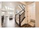 Inviting entryway with staircase and hardwood floors leading to a bright, open living area at 14437 Grape St, Thornton, CO 80602