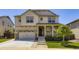 Charming two-story home with a well-manicured front yard and inviting porch at 14437 Grape St, Thornton, CO 80602