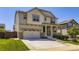 Charming two-story home featuring a stone facade, covered porch, attached two car garage, and well-maintained lawn at 14437 Grape St, Thornton, CO 80602