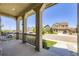 Spacious front porch with pillars overlooking the neighborhood and street at 14437 Grape St, Thornton, CO 80602