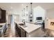 Modern kitchen featuring a large island, stainless steel appliances, and an open floor plan at 14437 Grape St, Thornton, CO 80602