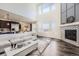 Bright living room with a cozy fireplace, stylish decor, and an open floor plan at 14437 Grape St, Thornton, CO 80602