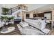 Open-concept living area with a staircase, piano, and modern kitchen, perfect for entertaining and Gathering living at 14437 Grape St, Thornton, CO 80602