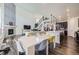 Open concept living space showcasing modern furniture, a fireplace, and an open floor plan at 14437 Grape St, Thornton, CO 80602