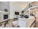Bright living room featuring a fireplace, hardwood floors, and contemporary furnishings at 14437 Grape St, Thornton, CO 80602