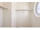 Bright walk-in closet with shelving and a unique round window at 14437 Grape St, Thornton, CO 80602