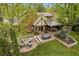 Aerial view showcasing the backyard with outdoor dining, fire pit, and landscaped lawn at 6248 S Coventry Ln, Littleton, CO 80123