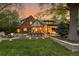 Spacious backyard with brick home, outdoor dining and lounge areas, and lush lawn at 6248 S Coventry Ln, Littleton, CO 80123