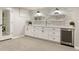 Basement with ample storage, custom cabinets and beverage cooler at 6248 S Coventry Ln, Littleton, CO 80123