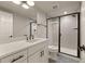 Modern bathroom features black shower trim, neutral subway tile and elegant patterned floor at 6248 S Coventry Ln, Littleton, CO 80123