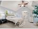 Bright bedroom with vaulted ceilings, a ceiling fan, and a large window providing natural light at 6248 S Coventry Ln, Littleton, CO 80123