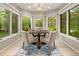 Dining room featuring many windows, a round table, and seating for four at 6248 S Coventry Ln, Littleton, CO 80123