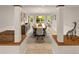 Open-concept dining room featuring a large table with seating for eight, wainscoting, and a view into the backyard at 6248 S Coventry Ln, Littleton, CO 80123
