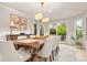 Bright dining room featuring a large wooden table, seating for eight, wainscoting, and sliding doors to the backyard at 6248 S Coventry Ln, Littleton, CO 80123