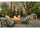 Outdoor stone fire pit with lounge seating and a built-in grill area for entertaining at 6248 S Coventry Ln, Littleton, CO 80123