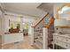Inviting foyer with staircase featuring wrought iron railings and open access to the dining area at 6248 S Coventry Ln, Littleton, CO 80123