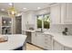 Bright, updated kitchen with white cabinets, quartz countertops, subway tile backsplash, and stainless steel appliances at 6248 S Coventry Ln, Littleton, CO 80123