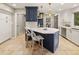 A kitchen featuring blue and white cabinets, a large island, and stainless steel appliances at 6248 S Coventry Ln, Littleton, CO 80123