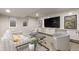 Cozy finished basement living room with ample seating, large TV, and stylish decor at 6248 S Coventry Ln, Littleton, CO 80123