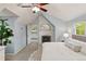 This main bedroom features a painted brick fireplace, a ceiling fan, and natural lighting from the windows at 6248 S Coventry Ln, Littleton, CO 80123